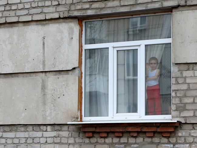 A small child waves from the window of a building in the small town of Severodonetsk, Donetsk Region. Picture: AFP