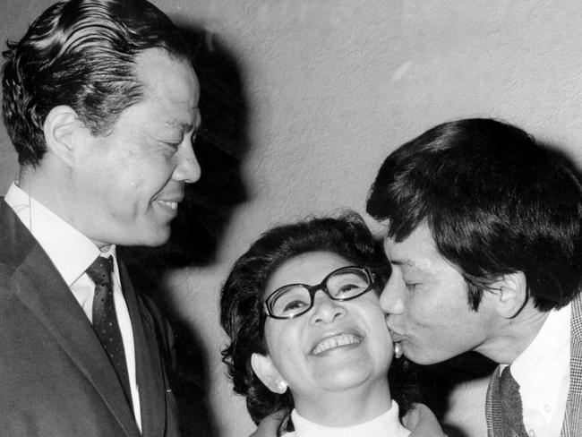 Melbourne’s first Chinese city councillor, Cr David Wang, and his wife, Mabel, are congratulated by their eldest son, Chris in 1969. Picture: HWT Library.