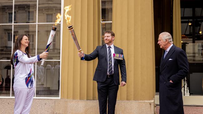 King Charles at Buckingham Palace with Dan Keighran, Angela Brient and the Legacy torch. Pic: Callum Smith