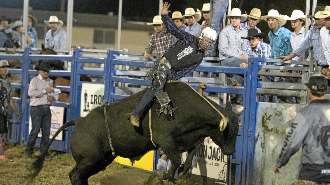 HOLD ON TIGHT: Josh Jones on his way to qualifying for the final in the open bullride at the Lawrence Twilight Rodeo. Picture: Adam Hourigan