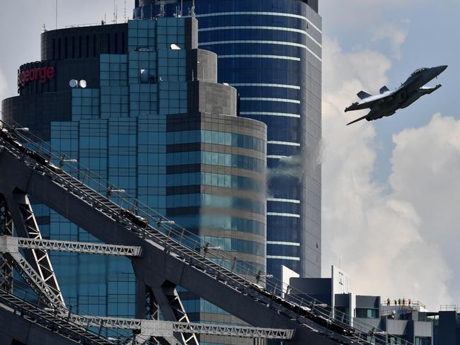 A Royal Australian Air Force EA-18G Growler flies over the Brisbane skyline. Picture: AAP