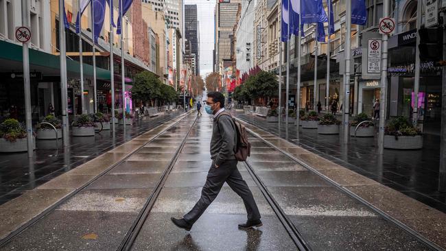 A man walks in Melbourne’s empty Bourke Street on Thursday as the snap lockdown looms. Picture: Jake Nowakowski