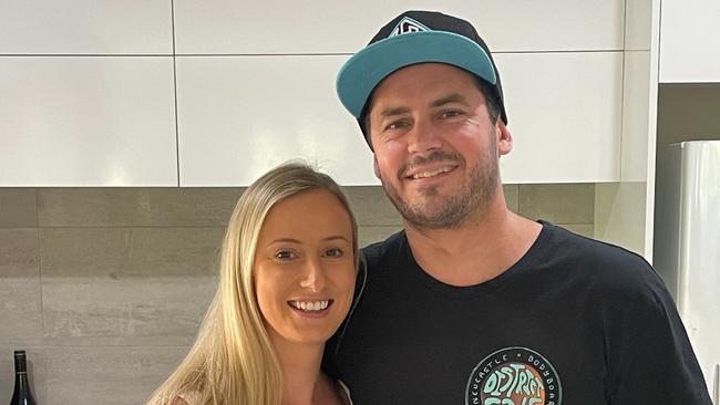 Newcastle bodyboarder Ryan Duck at home with his partner Sophie Ceccato. The 35-year-old has been released from hospital after allegedly being stabbed multiple times at Pacific Palms on November 27, 2022. Picture: Dan Proudman