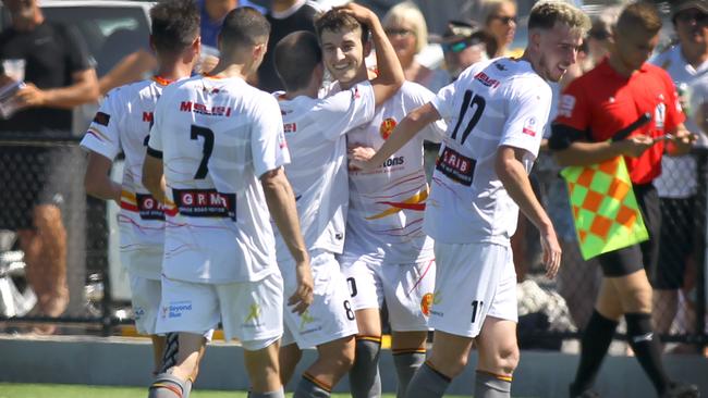 Off-season recruit Josh Mori is congratulated by his MetroStars teammates, after scoring in the 8-0 rout of Cumberland United. Picture: AAP Image/Dean Martin