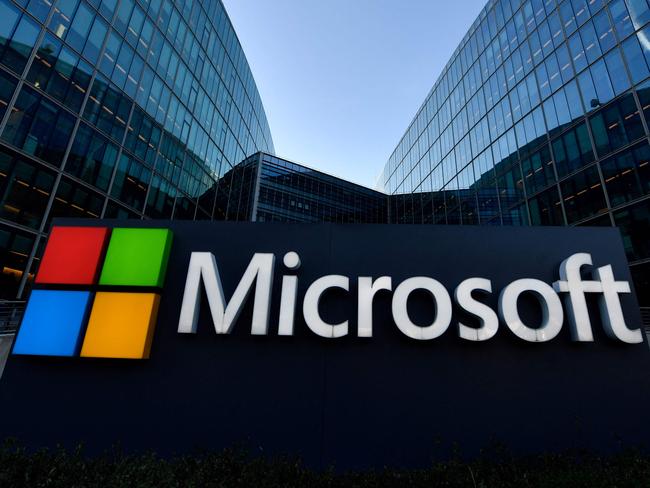 (FILES) The logo of French headquarters of American multinational technology company Microsoft, is pictured outside on March 6, 2018 in Issy-Les-Moulineaux, a Paris' suburb. Microsoft on May 13, 2025 said it was slashing unnecessary layers of management and seizing the benefits of new technology as reports said the tech behemoth was laying off thousands of workers. The company, which is advancing in its plans of deploying AI across all its products, also said it was in a process to 