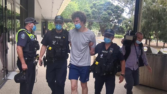 The man is led away by police. Picture: Andrew Hough