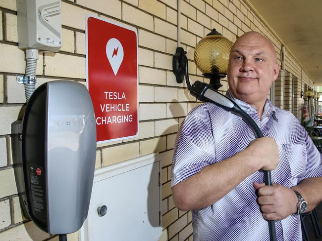 Nanango Star Motel owner Andrew Beck with newly installed Tesla vehicle charger. Photo: Dominic Elsome