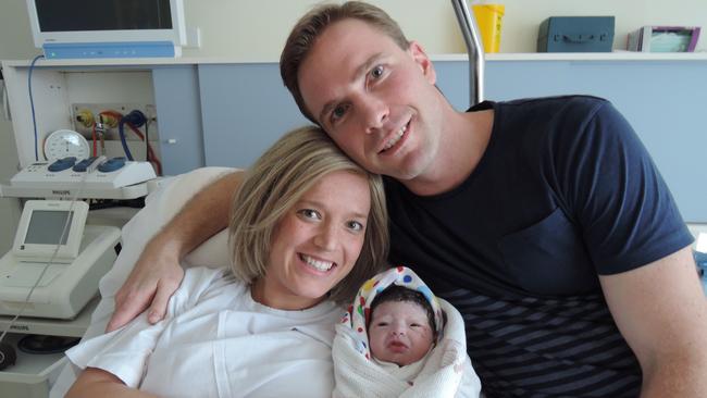 Ainslie gave birth during treatment for breast cancer. With newborn Isobel and husband Angus. Picture: Supplied