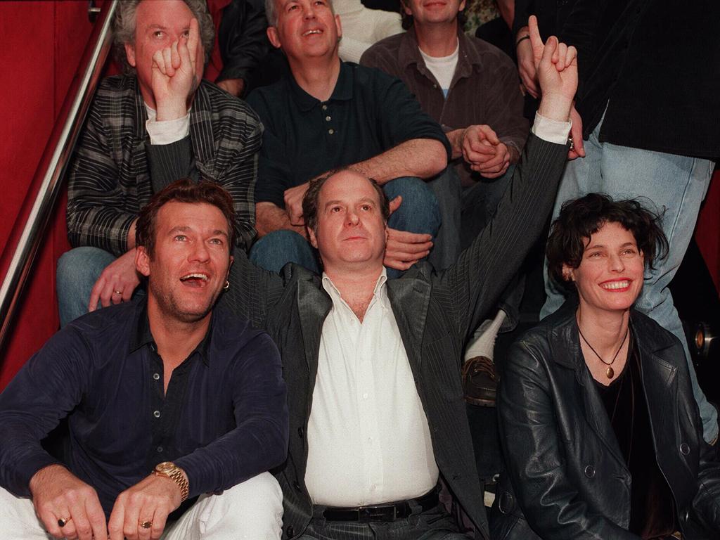 Gudinski, centre, flanked by singer Jimmy Barnes, left, and Deborah Conway during Mushroom's 25th anniverary celebrations in 1997.