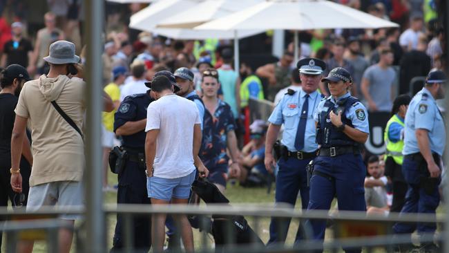 Police with a sniffer dog inside the Ultra Australia 2019 music festival at Parramatta Park.  Picture: Damian Shaw