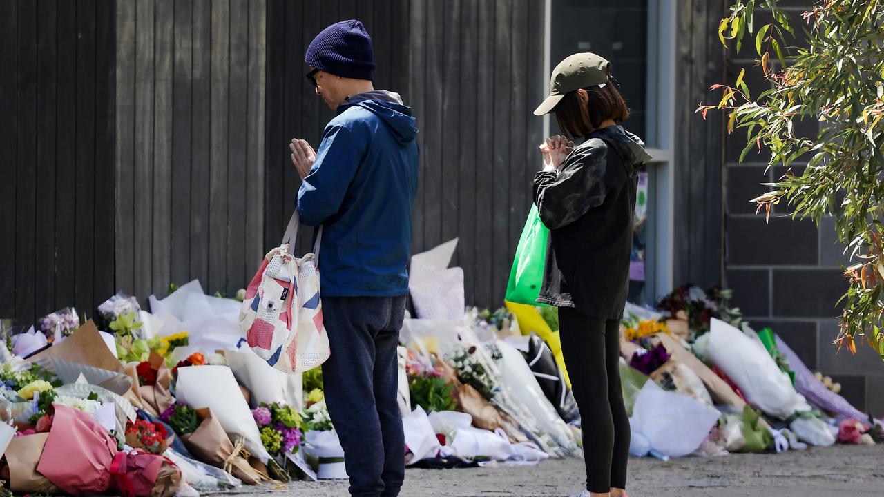 A couple pray outside Auburn South Primary School in Hawthorn East as floral tributes for Jack grow. Picture: NewsWire/Ian Currie