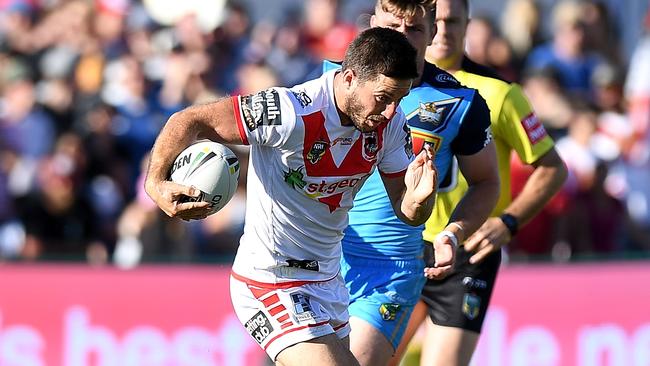 Dragons halfback Ben Hunt breaks through the Titans defence at Clive Berghofer Stadium in Toowoomba,