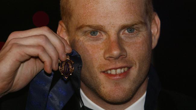 A younger, wide-eyed Cooney with his medal.