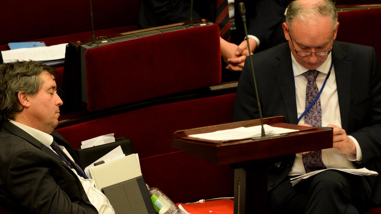 Tim Quilty from the Liberal Democrats sleeps during the legislation debate as David Limbrick checks his phone. Picture: Andrew Henshaw