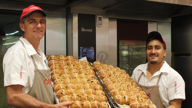 Coles employees with Hot Cross Buns. Picture: Supplied