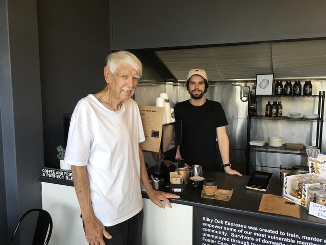 Local resident Phil Ryan (white t-shirt), with Silky Oak barista Rob Szakaly) has lived in Chermside West for 55 years and remembers the days he found cows in his yard.