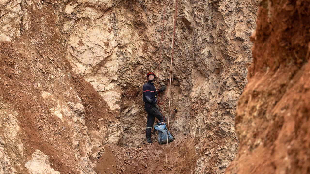 A Moroccan emergency services climber works on the rescue of five-year-old boy Rayan.