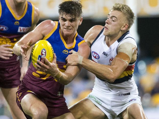 Ben Keays of the Lions (centre) is tackled by Hugh Greenwood of the Crows during the Round 9 AFL match between the Brisbane Lions and the Adelaide Crows at the Gabba in Brisbane, Saturday, May 20, 2017. (AAP Image/Glenn Hunt) NO ARCHIVING, EDITORIAL USE ONLY