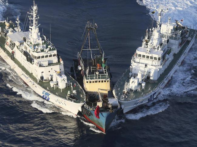 A fishing boat, centre, is surrounded by Japan Cost Guard's patrol boats after activists descended from the boat on Uotsuri Island, one of the islands of Senkaku in Japanese and Diaoyu in Chinese, in East China Sea in 2012. Picture: AP