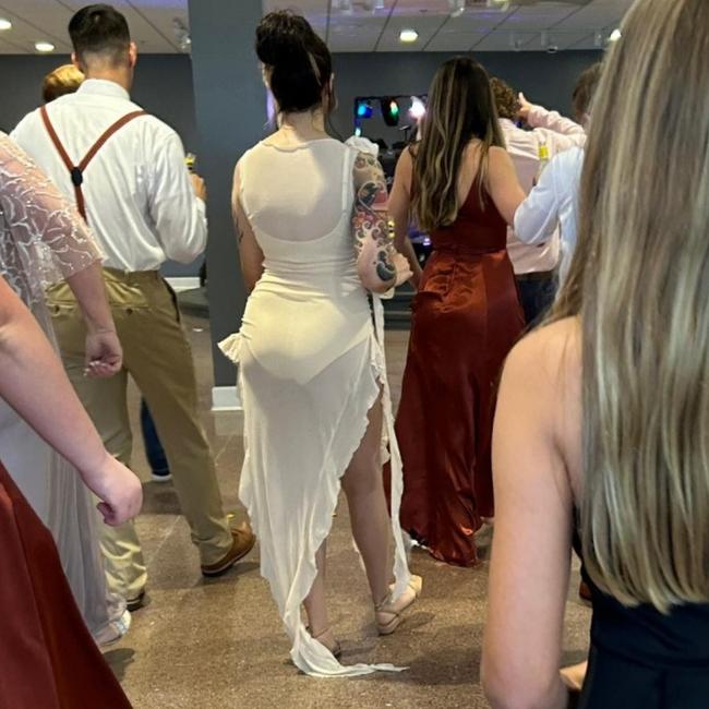 A wedding guest has been lashed for wedding an outfit that flashed her undies. Picture: Facebook/thatsitimweddingshaming