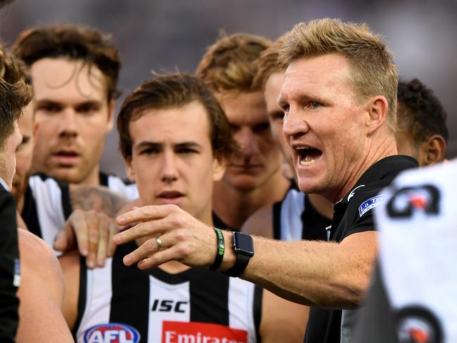 Collingwood coach Nathan Buckley chats with his players  at the break during the Round 2 AFL match between the Collingwood Magpies and the Greater Western Sydney (GWS) Giants at the MCG in Melbourne, Saturday, March 31, 2018. (AAP Image/Joe Castro) NO ARCHIVING, EDITORIAL USE ONLY