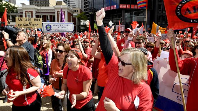 Teachers and other union members wear red shirts as they take to the streets of Adelaide to push their pay-rise case with the state government  Picture: AAP