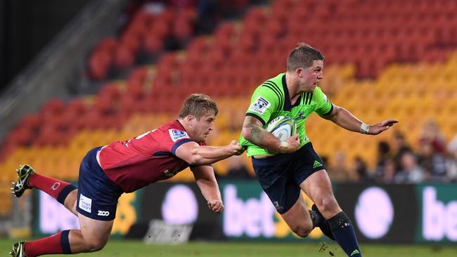 Andrew Ready of the Reds attempts to tackle Teihorangi Walden of the Highlanders at Suncorp Stadium in Brisbane.