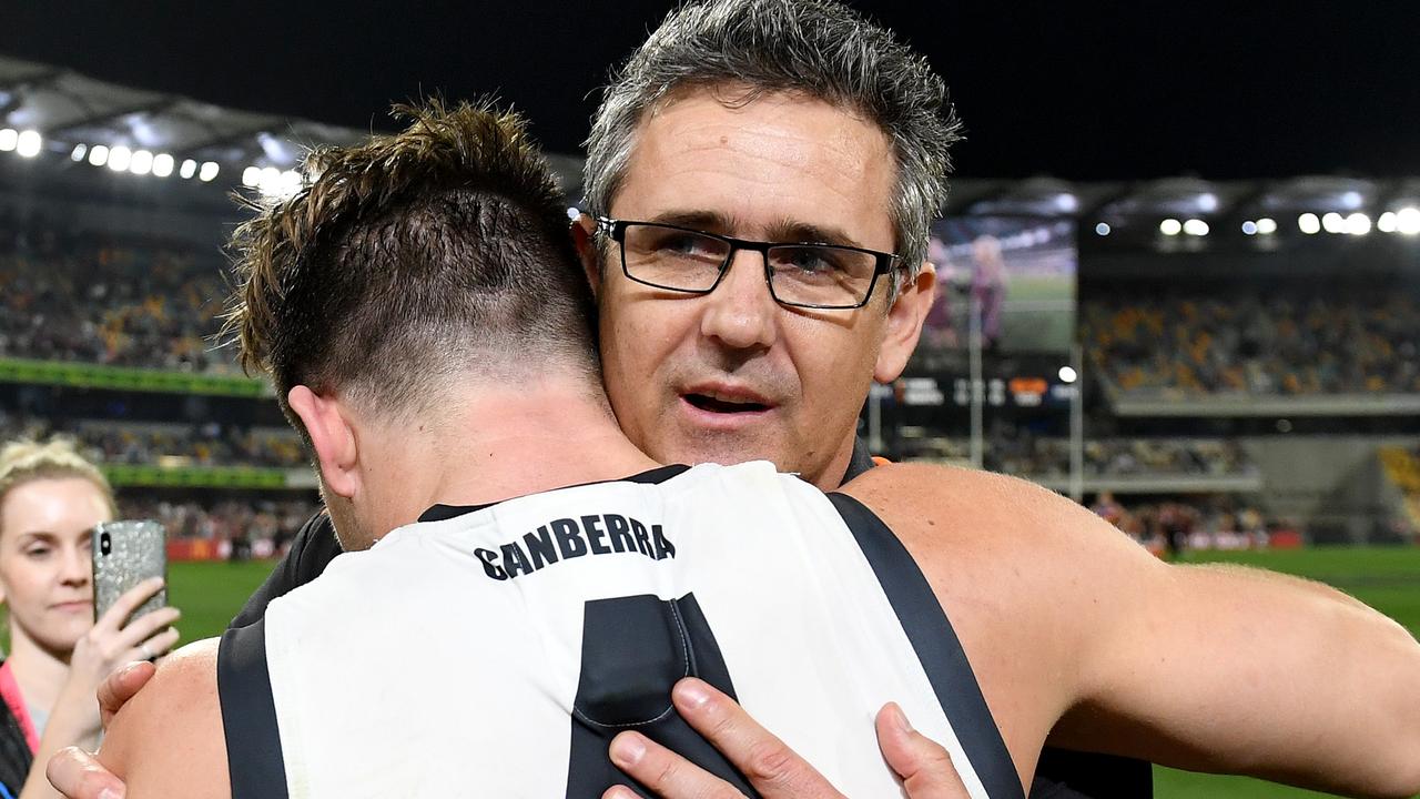 Leon Cameron embraces Toby Greene at the Gabba on Saturday night.