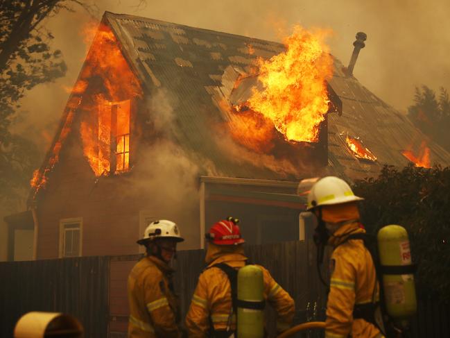 Firefighters battle to save a home engulfed by flames. Picture: Sam Ruttyn