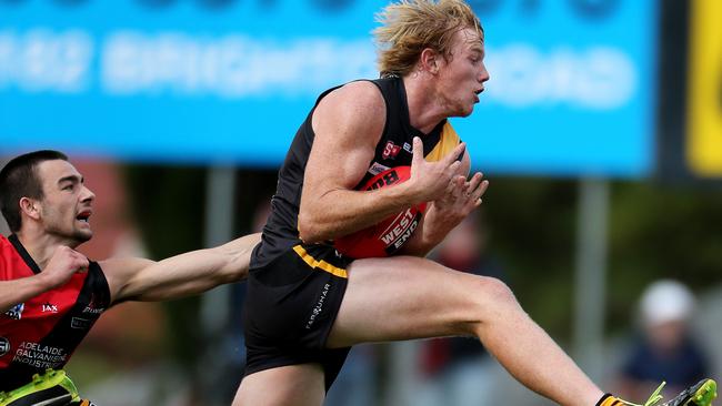 03/04/16 Glenelg v West Adelaide at Glenelg Oval. Josh Scott marks in front of Brett Turner. photo Calum Robertson