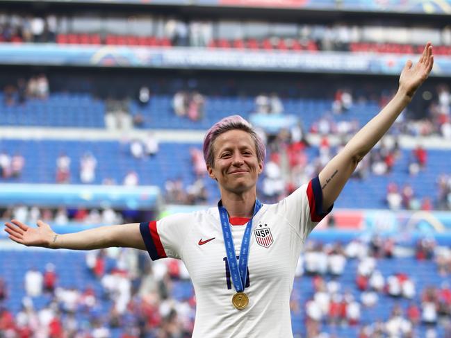 LYON, FRANCE - JULY 07:  Megan Rapinoe of the USA celebrates with the FIFA Women's World Cup Trophy, the Golden Boot and The Golden Ball following the 2019 FIFA Women's World Cup France Final match between The United States of America and The Netherlands at Stade de Lyon on July 07, 2019 in Lyon, France. (Photo by Alex Grimm/Getty Images)