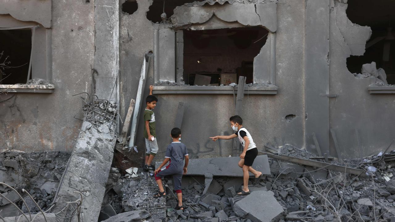 Palestinian children climb on the rubble of a destroyed home the day after an Israeli air strike on the Nuseirat refugee camp, in the central Gaza Strip. Picture: AFP