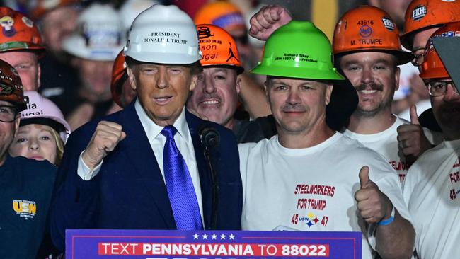 Donald Trump with members of "Steelworkers for Trump" at a campaign rally in October. Picture: AFP