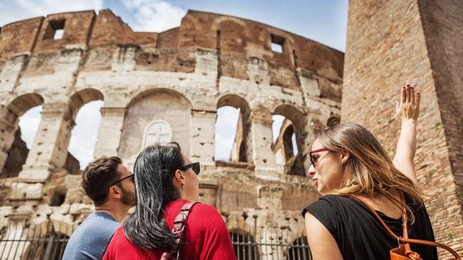 Tourists with a guide at the Coliseum, Rome.