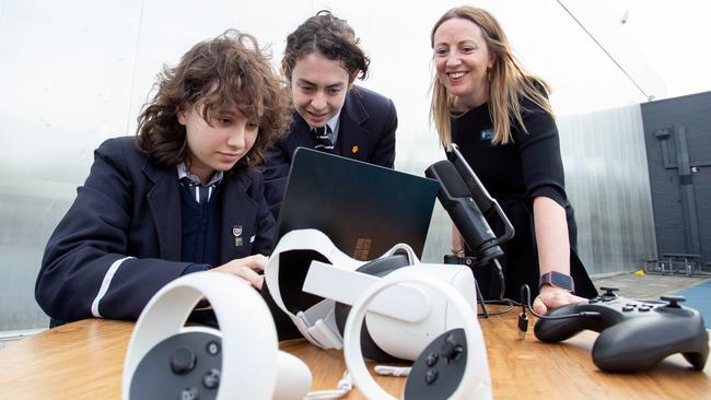 Adelaide’s Pulteney Grammar School is leading the way in implementation of AI. Pictured are students Emily Dwyer and Diesel Kereru with deputy principal Katherine Adnett. Picture: Brett Hartwig