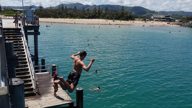 Jaden Coombes from Arrawarra takes the plunge at the Coffs Harbour Jetty on Boxing Day. Picture: Chris Knight