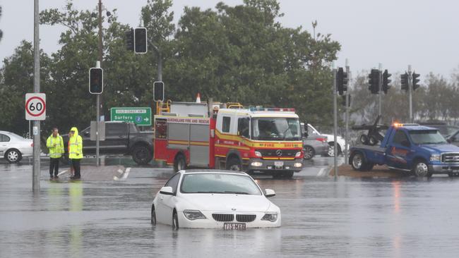 A car is flooded on the corner of the Gold Coast Highway in Southport. Picture: Jason O'Brien