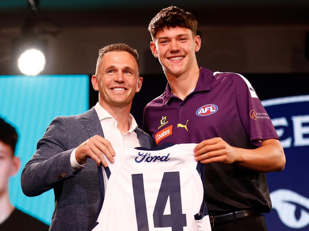 Connor O'Sullivan is handed the No.14 by Joel Selwood. Picture: Getty Images