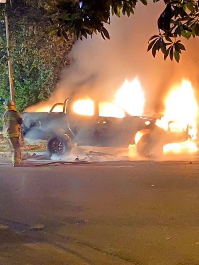 Fire crews work to extinguish a stolen car which was set on fire earlier this year.