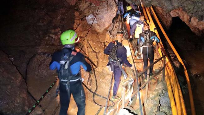 Thai rescue team members inside the cave where the 12 boys and their soccer coach were trapped, during the rescue attempt. Picture: Royal Thai Navy via AP