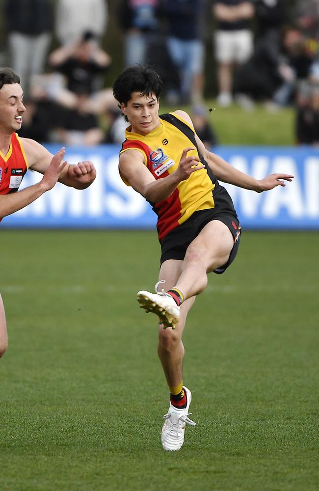 Josh’s brother Sean launches a kick. Picture: Andrew Batsch