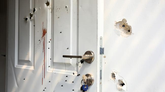 Bullet holes and blood stains on a door and walls of a house where civilians were killed in an attack by Hamas militants on the Kfar Aza kibbutz on October 7. A chunk of ABC staff seems not to understand the difference between racist slaughter and war. Picture: Alexi J. Rosenfeld/Getty Images