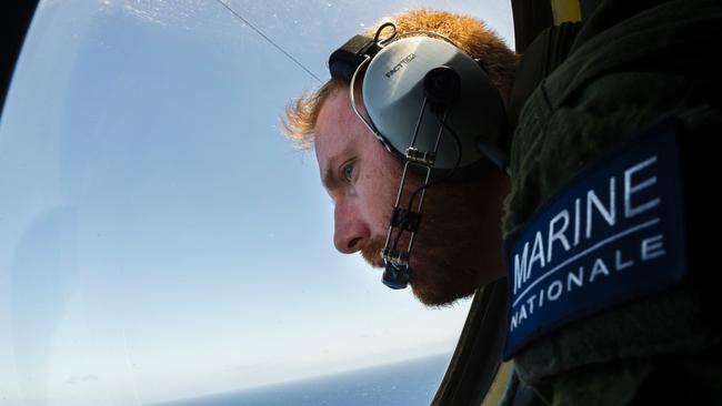 A French soldier aboard an aircraft looking out a window during searches for debris from the crashed EgyptAir flight MS804 over the Mediterranean Sea. Picture: Marine Nationale/AFP