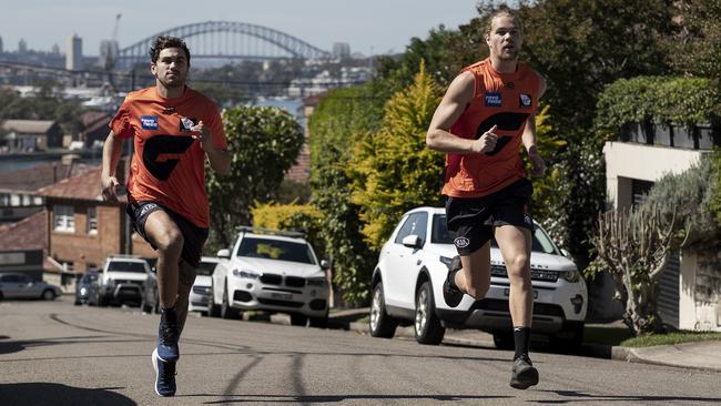 GWS Giants players Tim Taranto and Harry Himmelberg run hill sprints near their home in Sydney. Picture: Getty Images