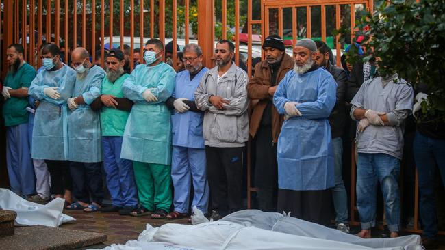 People mourn as they collect the bodies of Palestinians killed in an air strike. Picture: Ahmad Hasaballah