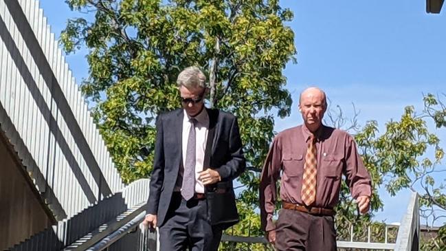 John Starmer (right) walks from Townsville Courthouse with a lawyer after facing court for the first time on indecent treatment of a child charges.