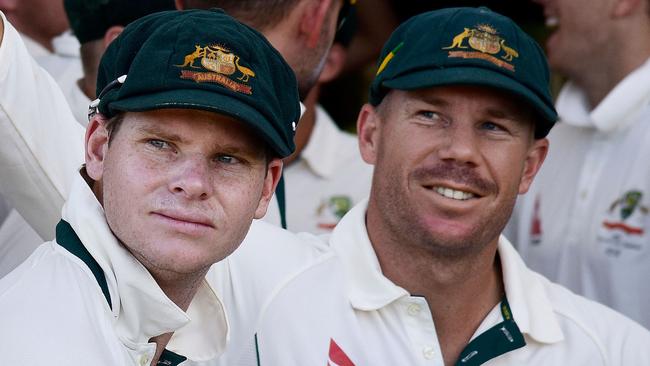 Steve Smith (L), then captain of Australia and teammate David Warner (R) wait to start the days play during day one of the second cricket Test match between New Zealand and Australia at the Hagley Park in Christchurch on February 20, 2016. Picture: AFP / Marty Melville.