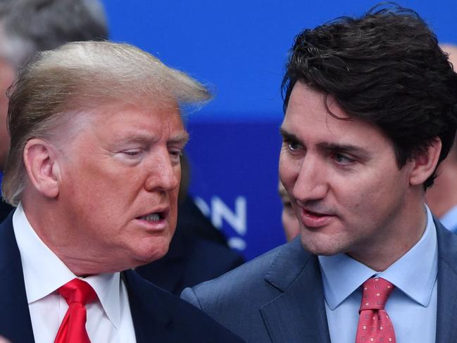 (FILES) US President Donald Trump (L) talks with Canada's Prime Minister Justin Trudeau during the plenary session of the NATO summit at the Grove hotel in Watford, northeast of London, on December 4, 2019. (Photo by Nicholas Kamm / AFP)