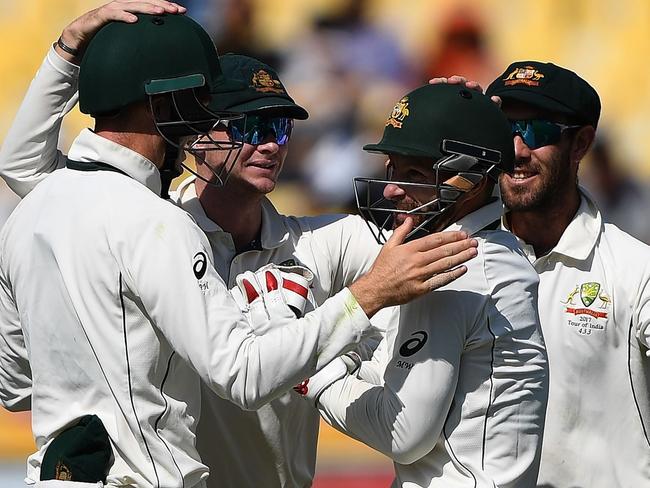 Australia's captain Steve Smith (2L) congratulates wicketkeeper Matthew Wade (2R) for the wicket of India's Karun Nair off the bowling of Nathan Lyon during the second day of play of the fourth and last Test cricket match between India and Australia at The Himachal Pradesh Cricket Association Stadium in Dharamsala on March 26, 2017. ----IMAGE RESTRICTED TO EDITORIAL USE - STRICTLY NO COMMERCIAL USE----- / GETTYOUT---- / AFP PHOTO / PRAKASH SINGH / ----IMAGE RESTRICTED TO EDITORIAL USE - STRICTLY NO COMMERCIAL USE----- / GETTYOUT