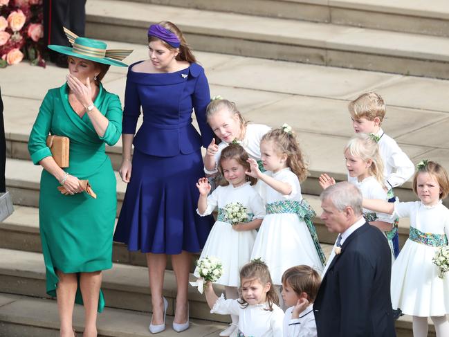 Sarah, Duchess of York and Princess Beatrice of York and the bridesmaids and page boys, including Princess Charlotte and Prince George, wave off Princess Eugenie of York and Mr. Jack Brooksbank following their wedding at St. George’s Chapel on October 12, 2018 in Windsor, England. (Photo by Andrew Matthews - WPA Pool/Getty Images)